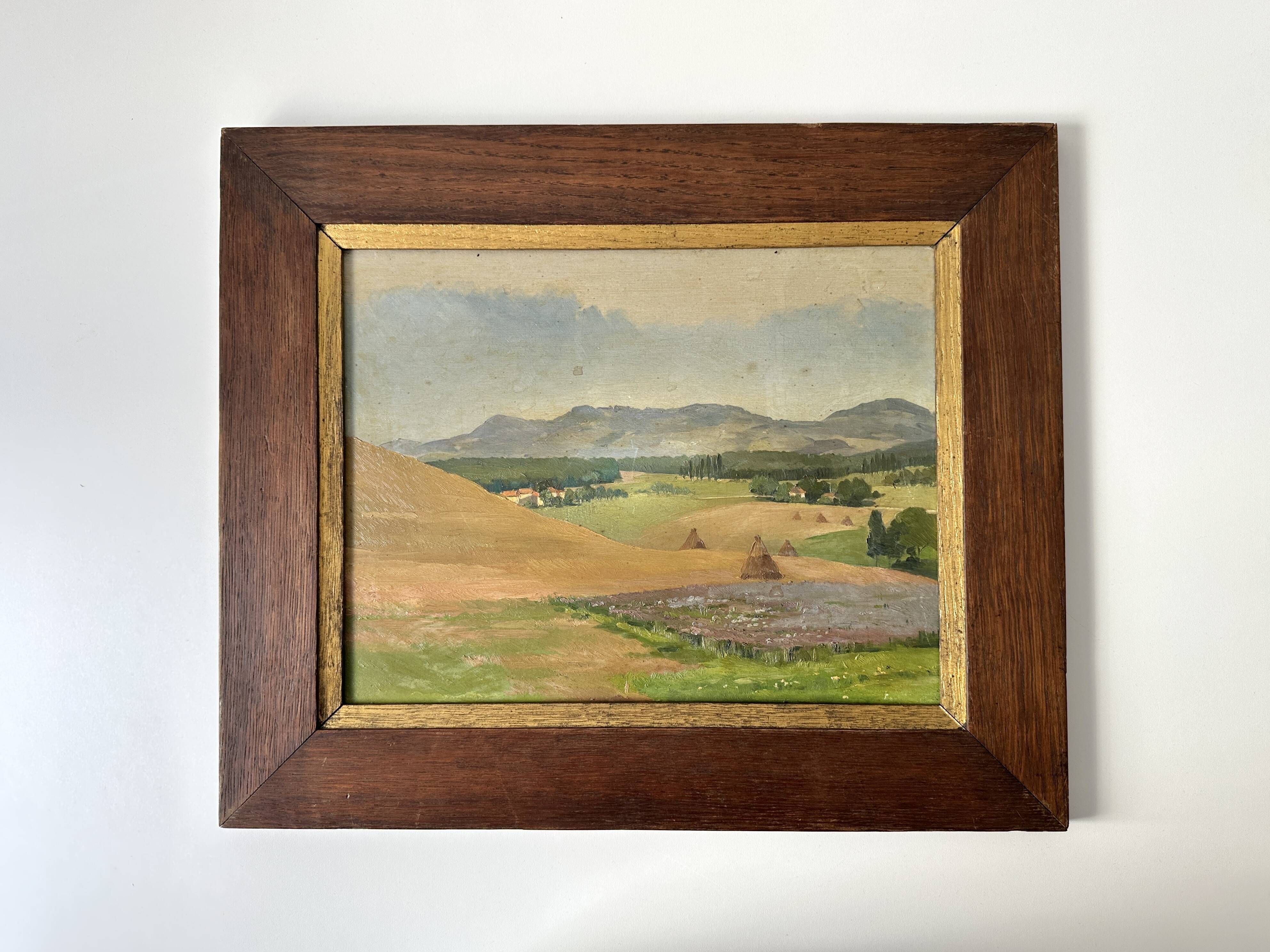 Old oil painting of a landscape on panel from 1920, haystacks.