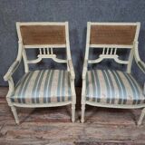 a pair of caned armchairs in the Louis XVI style, elegant and full of charm.