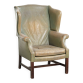 Old cow leather wingback armchair in English style with beautiful patina