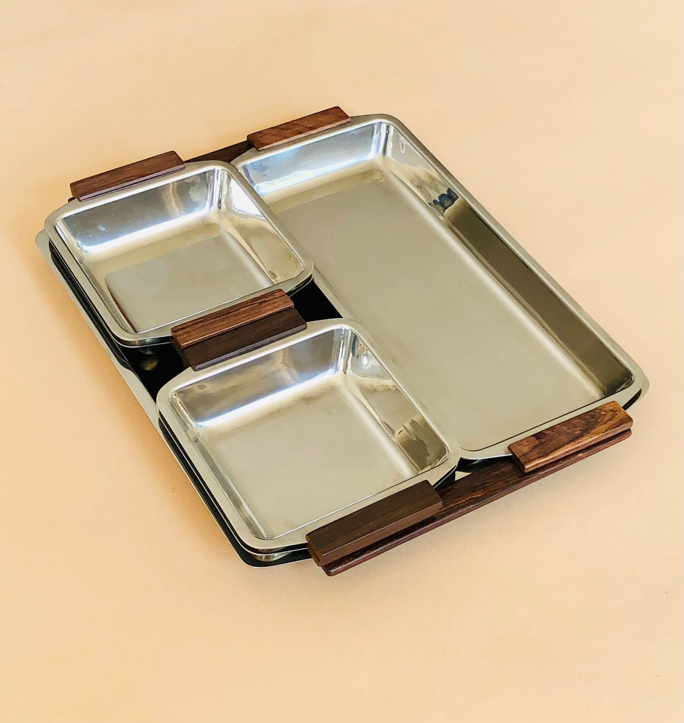 Service of Scandinavian dishes in stainless steel and teak 1970