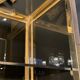 Hollywood Regency style bookcase shelf, gilded brass and black lacquered wood, 1970