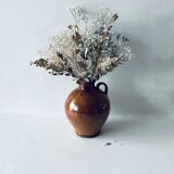 Old pitcher in glazed terracotta