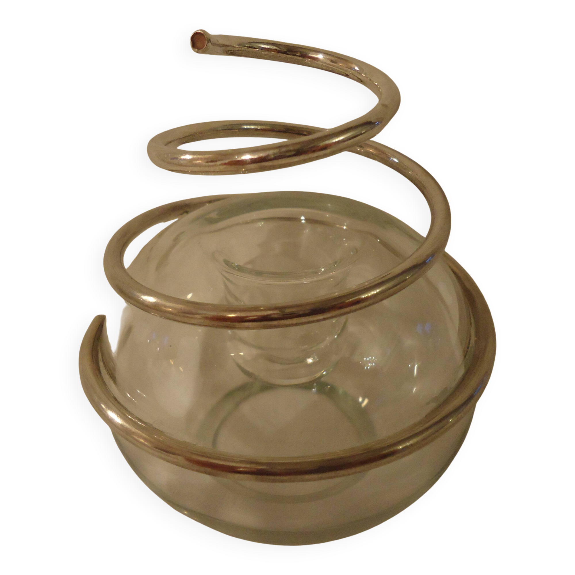 Round glass candle holder with silver-plated metal spiral.