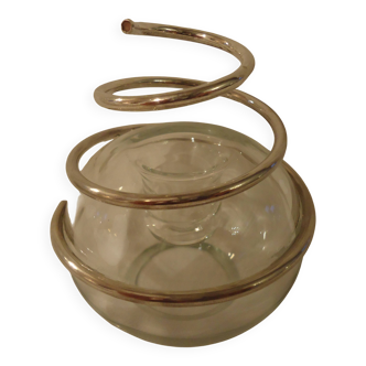 Round glass candle holder with silver-plated metal spiral.