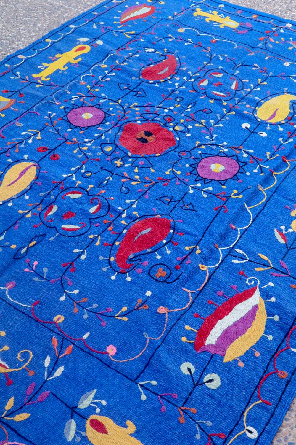 Midnight blue suzani kilim rug with embroidered patterns