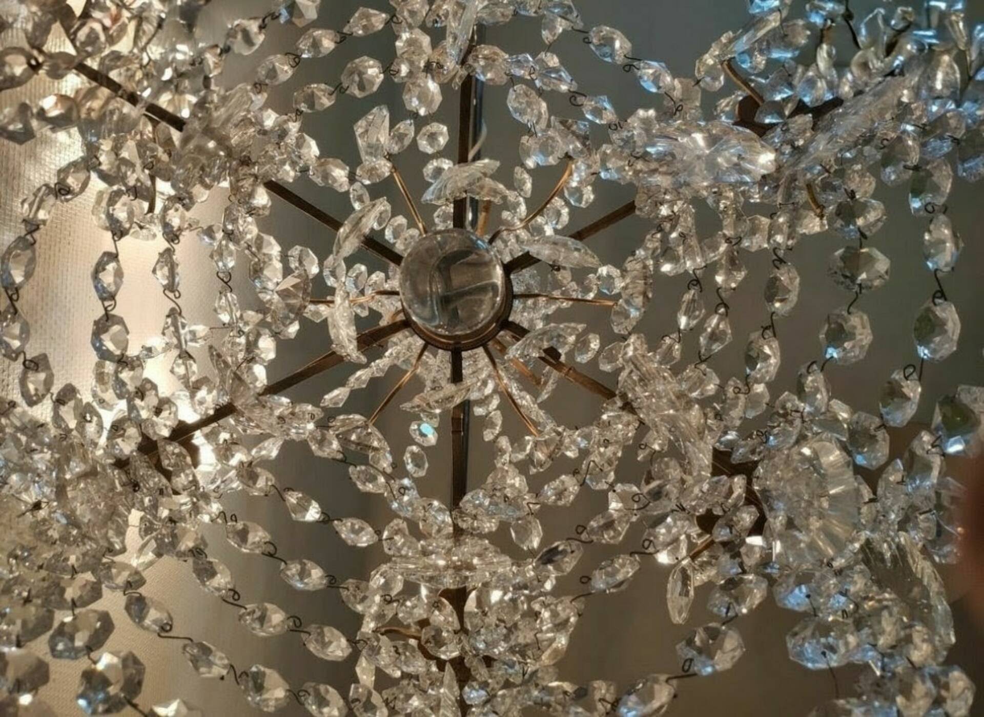 A pair of imposing, antique chandeliers with pendants.