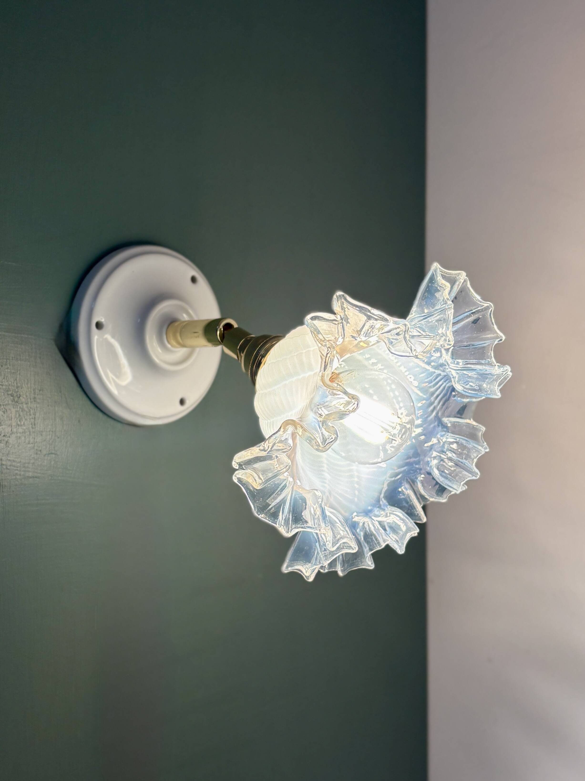 Vintage tulip glass wall light in transparent, slightly pearlescent white.