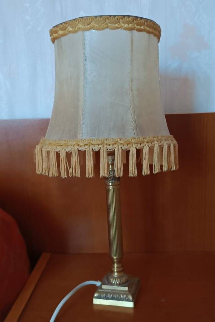 Brass bedside lamp with natural bladder shade.