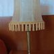 Brass bedside lamp with natural bladder shade.