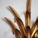 Applies "wheat sheaf" gold metal