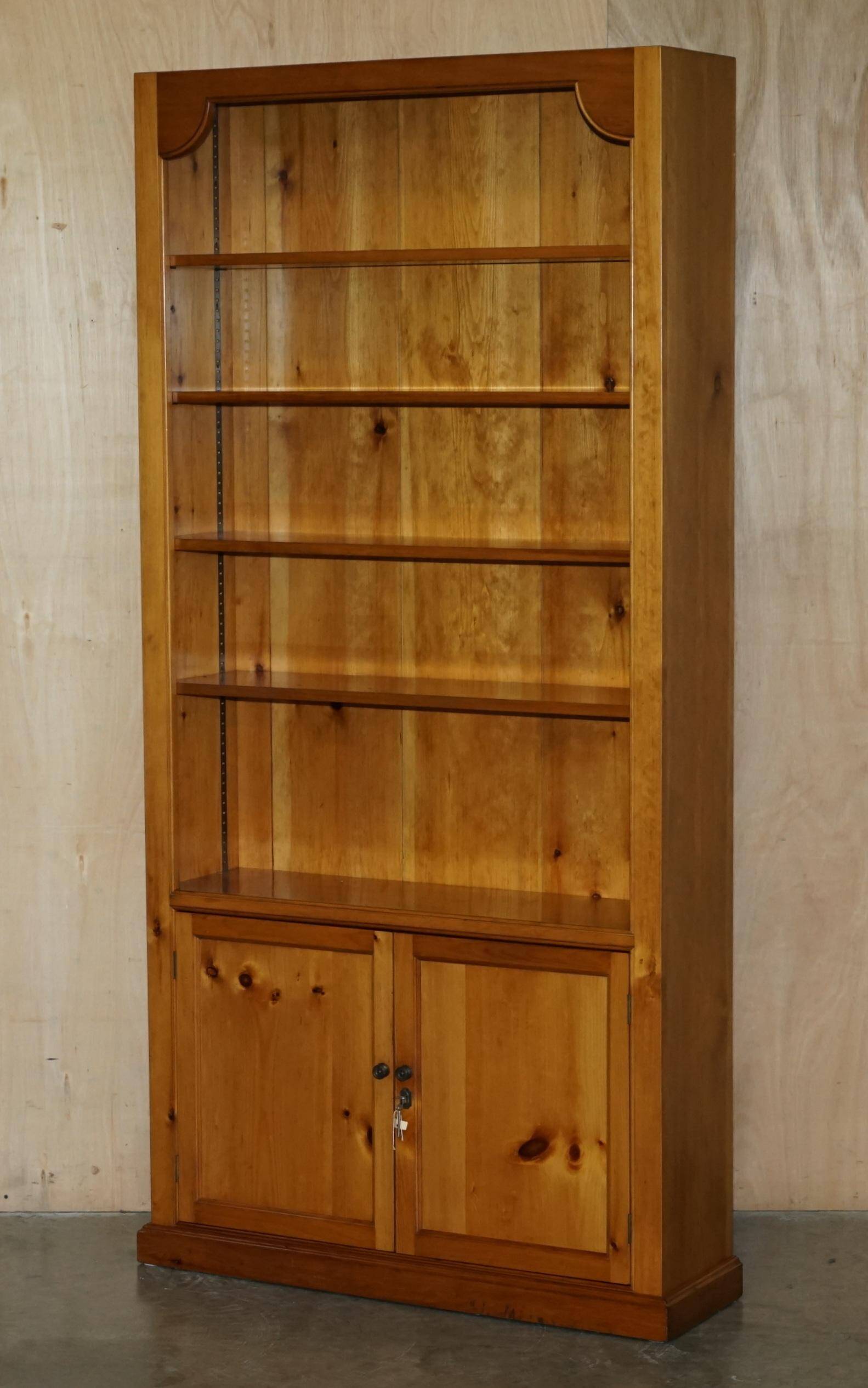 Pair of vintage cherry wood bookcases with lockable doors.