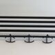 Designer coat rack in blackened metal