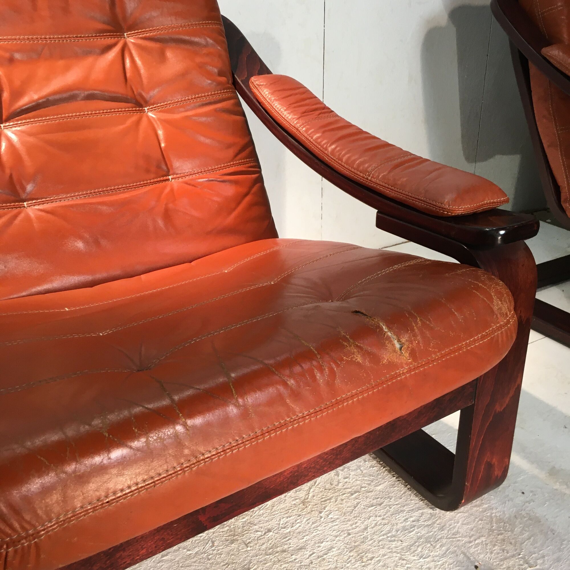 Duo of ochre leather and wood frame armchairs