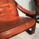 Duo of ochre leather and wood frame armchairs