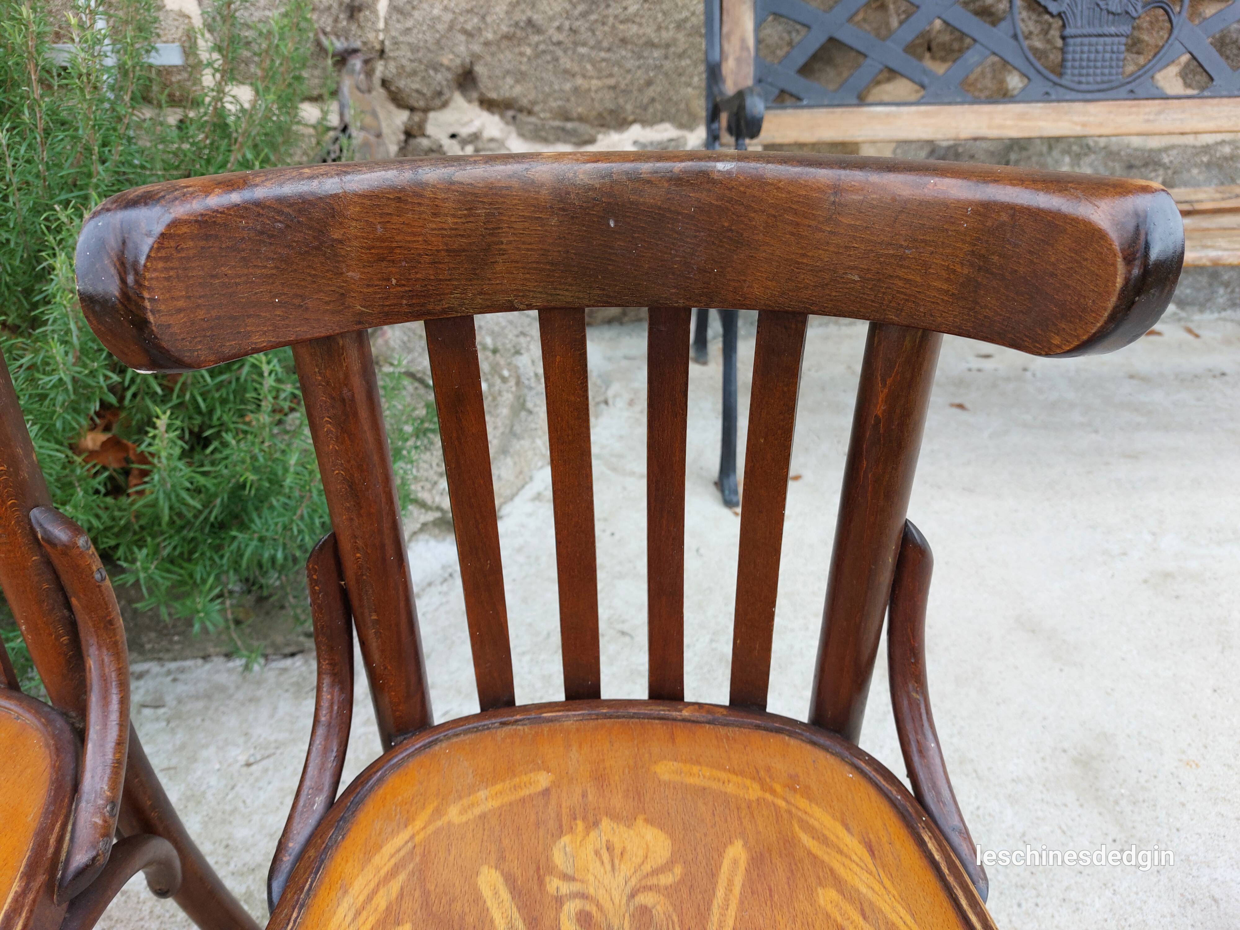 4 bentwood bistro chairs with a pattern on the seat