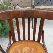 4 bentwood bistro chairs with a pattern on the seat
