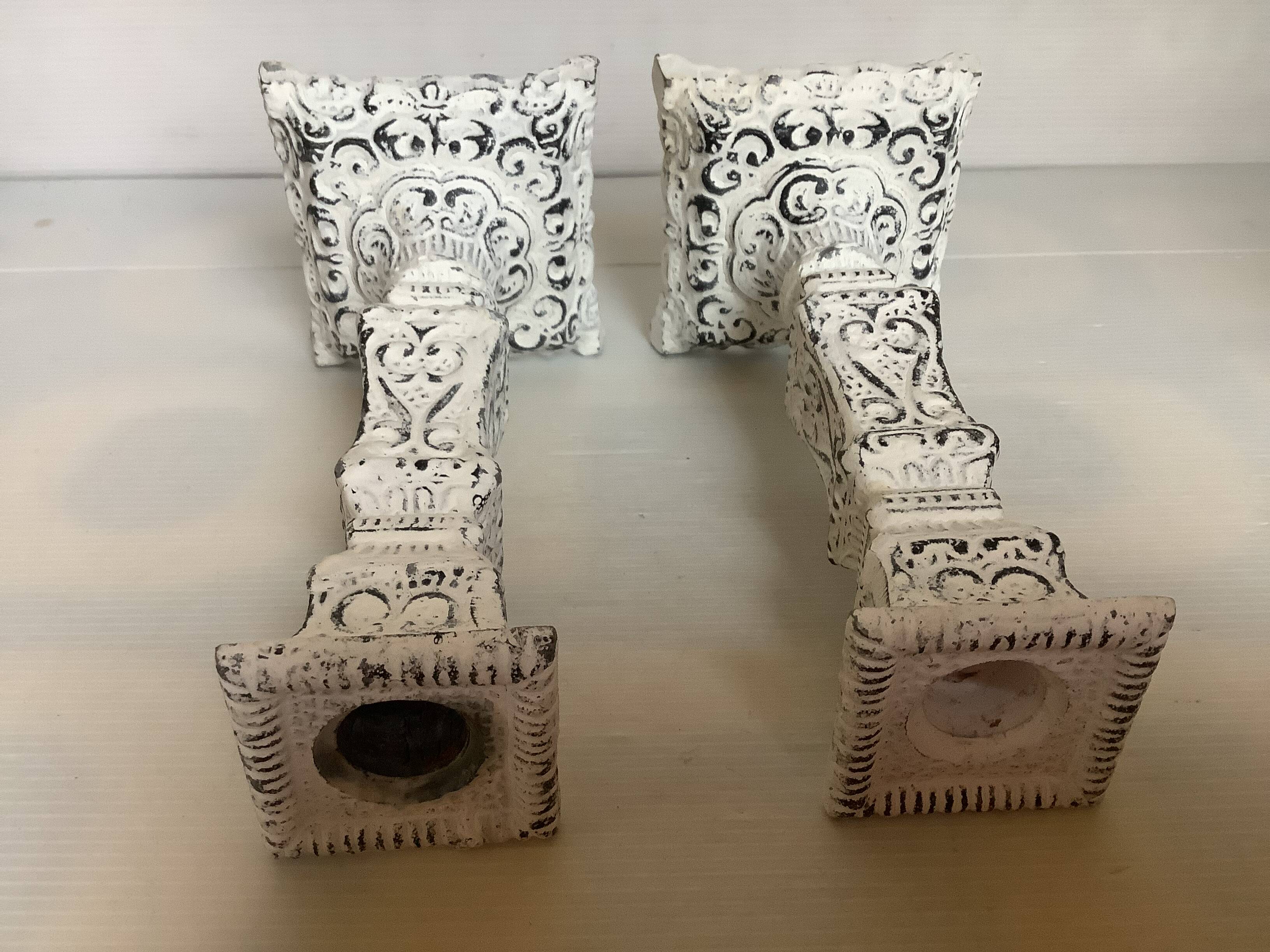 Pair of patinated cast iron candlesticks