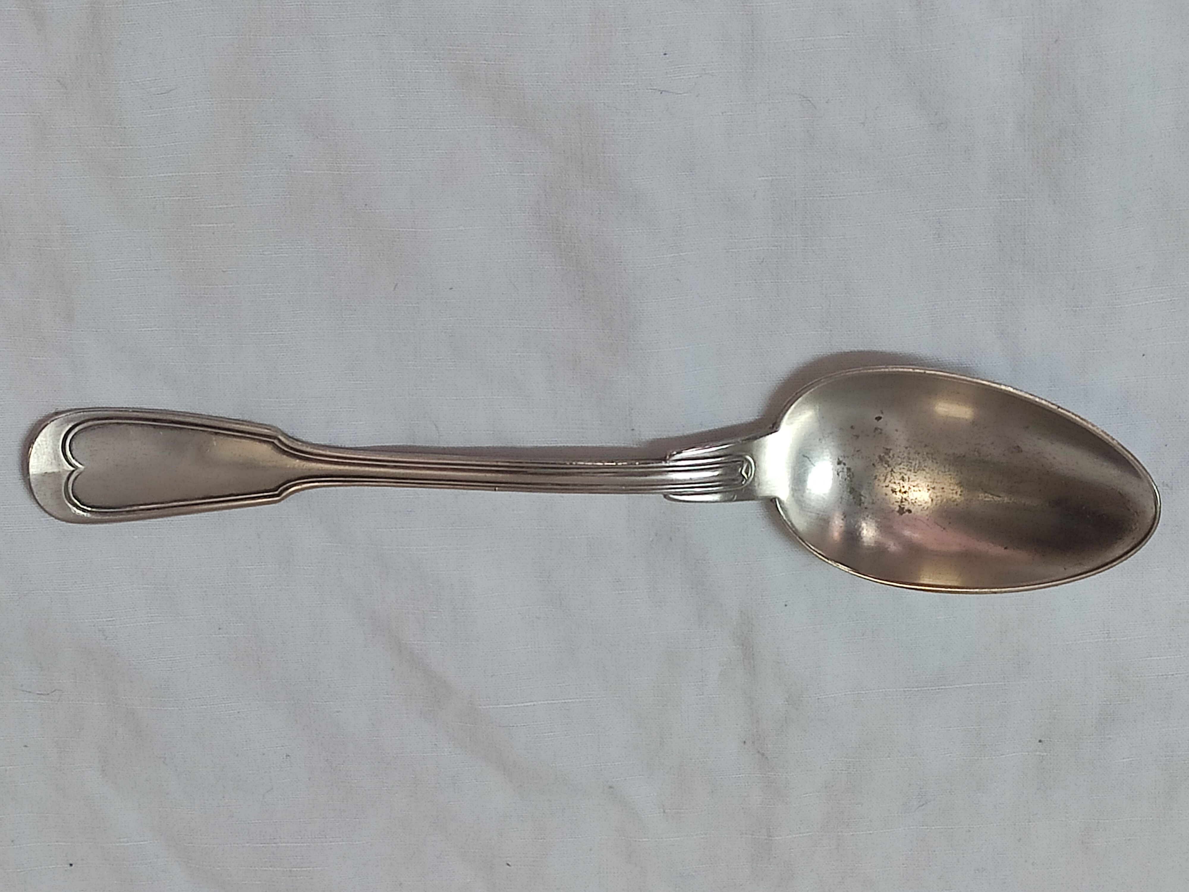 Serving spoon, silver metal.