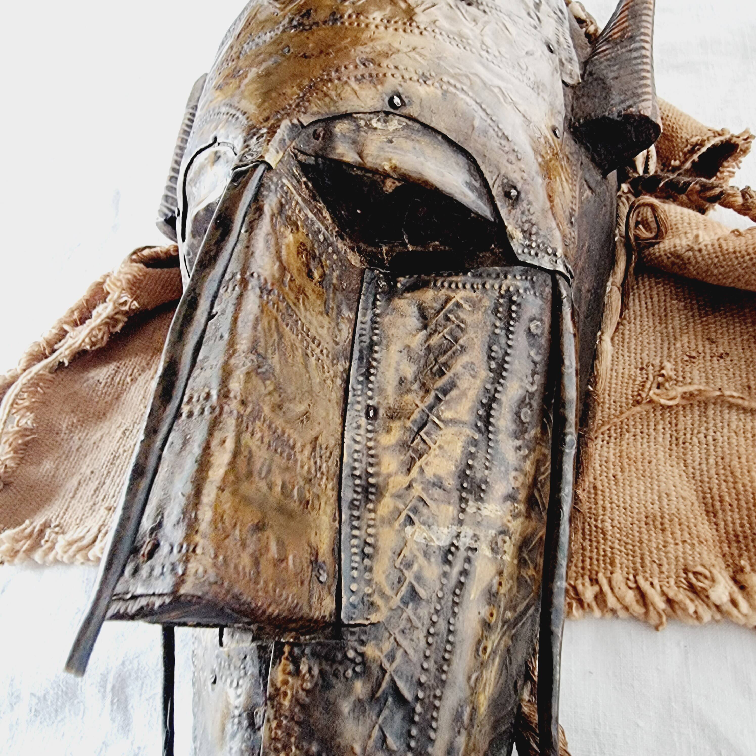 African mask from Mali from the N'Tomo tribe of Marka covered in chiseled brass