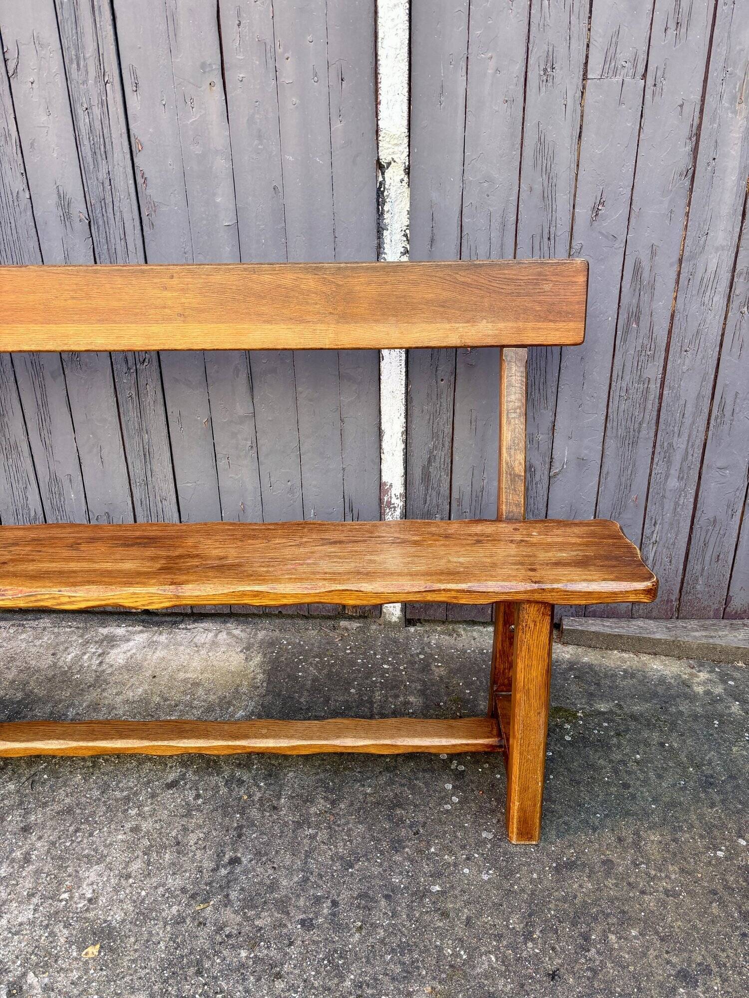 Brutalist bench with dark wood back