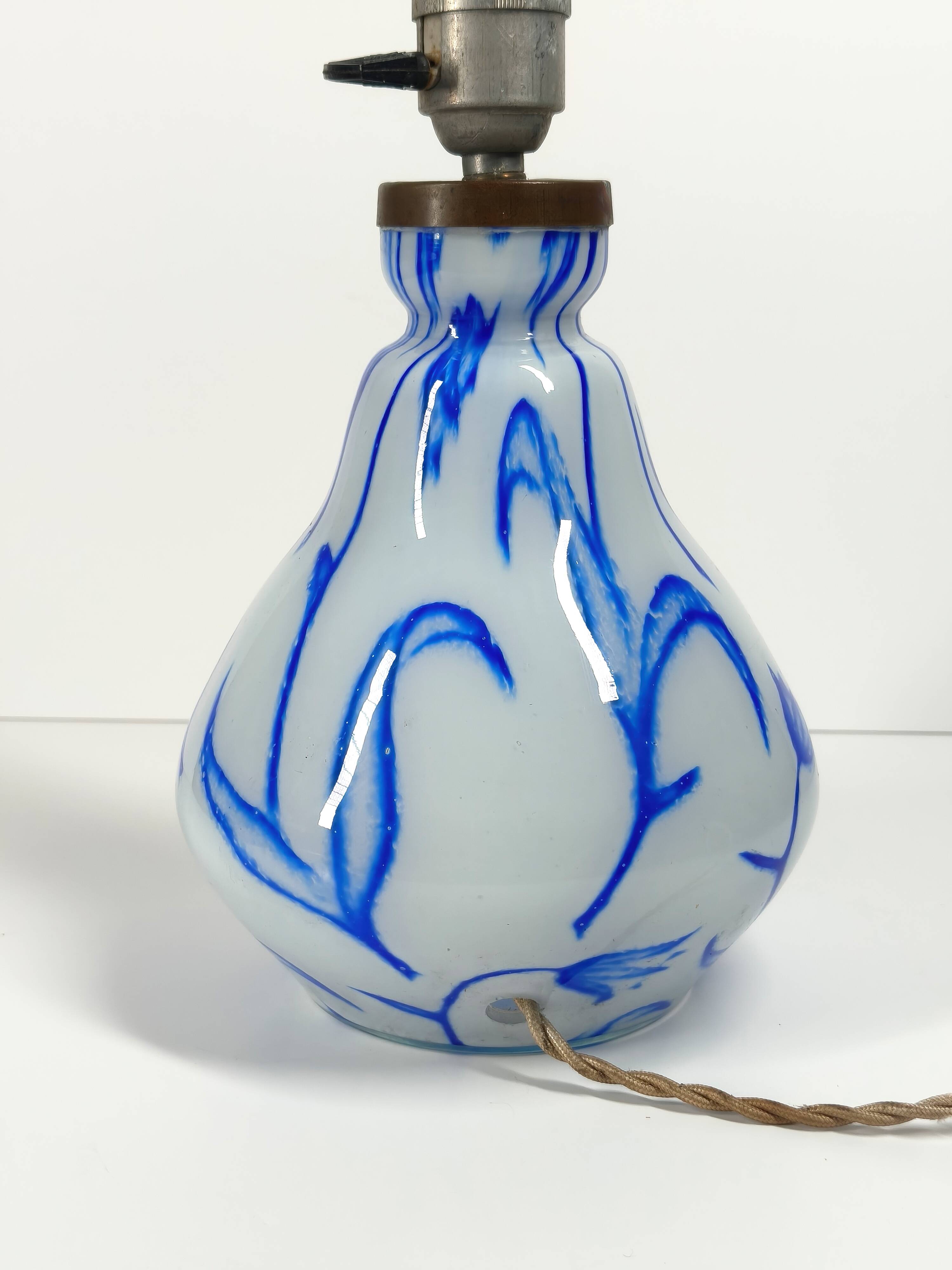 Antique table lamp in opaline glass with blue floral decoration.