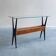 Table console ébénisée italienne des années 1950 avec plateau en verre et panier en treillis.