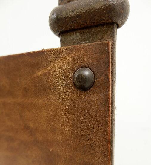 Curule armchair in wrought iron and leather