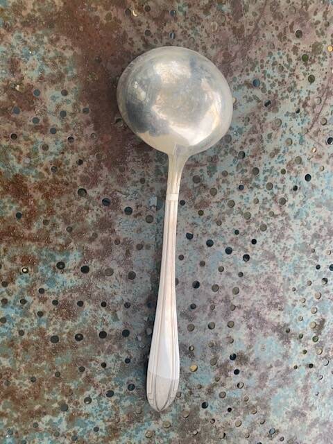 Lot of mismatched silver metal serving cutlery, a ladle and a fish knife