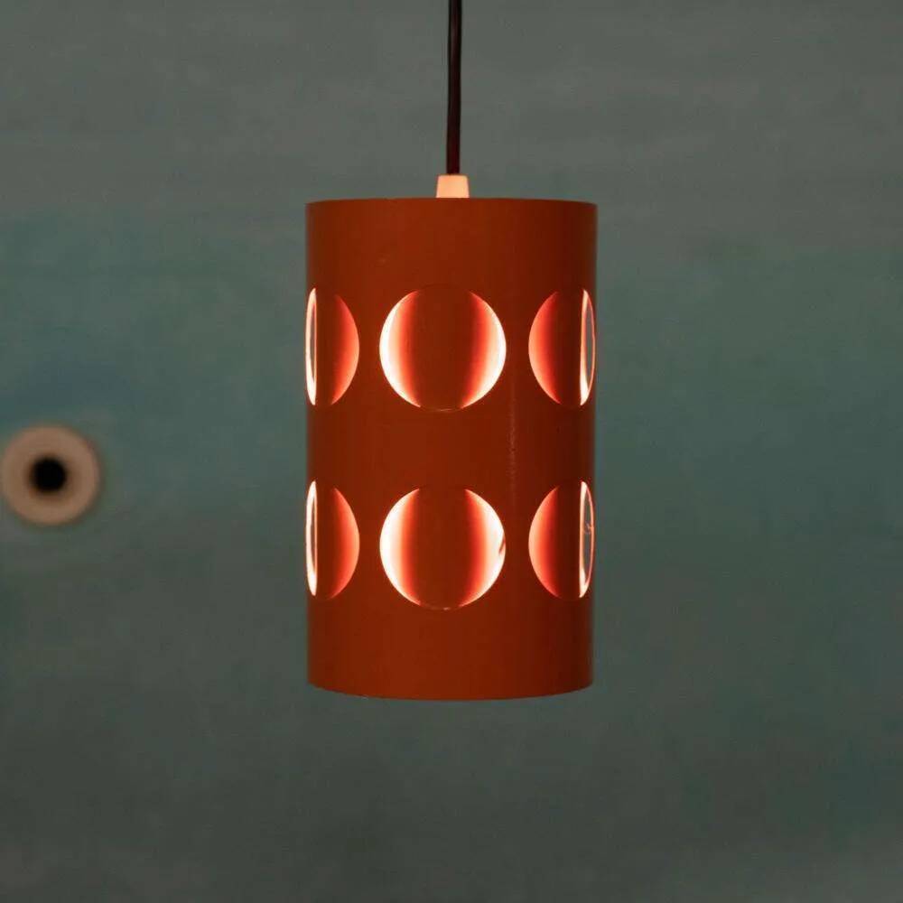 Vintage orange suspension light in a 1970s space age style.