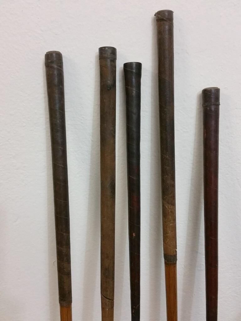 Old golf bag with 5 golf clubs