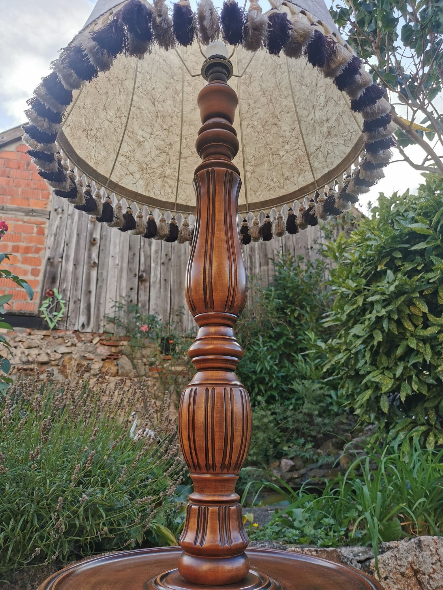 Turned wooden floor lamp with lampshade