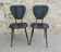 Pair of chairs with tapered metal legs and black Skaï, 60s