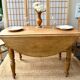 Round oak table with a drop leaf.