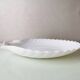 White ceramic dish shaped like 80s shells