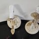 Pair of cream patinated metal wall sconces with floral decoration.