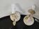 Pair of cream patinated metal wall sconces with floral decoration.