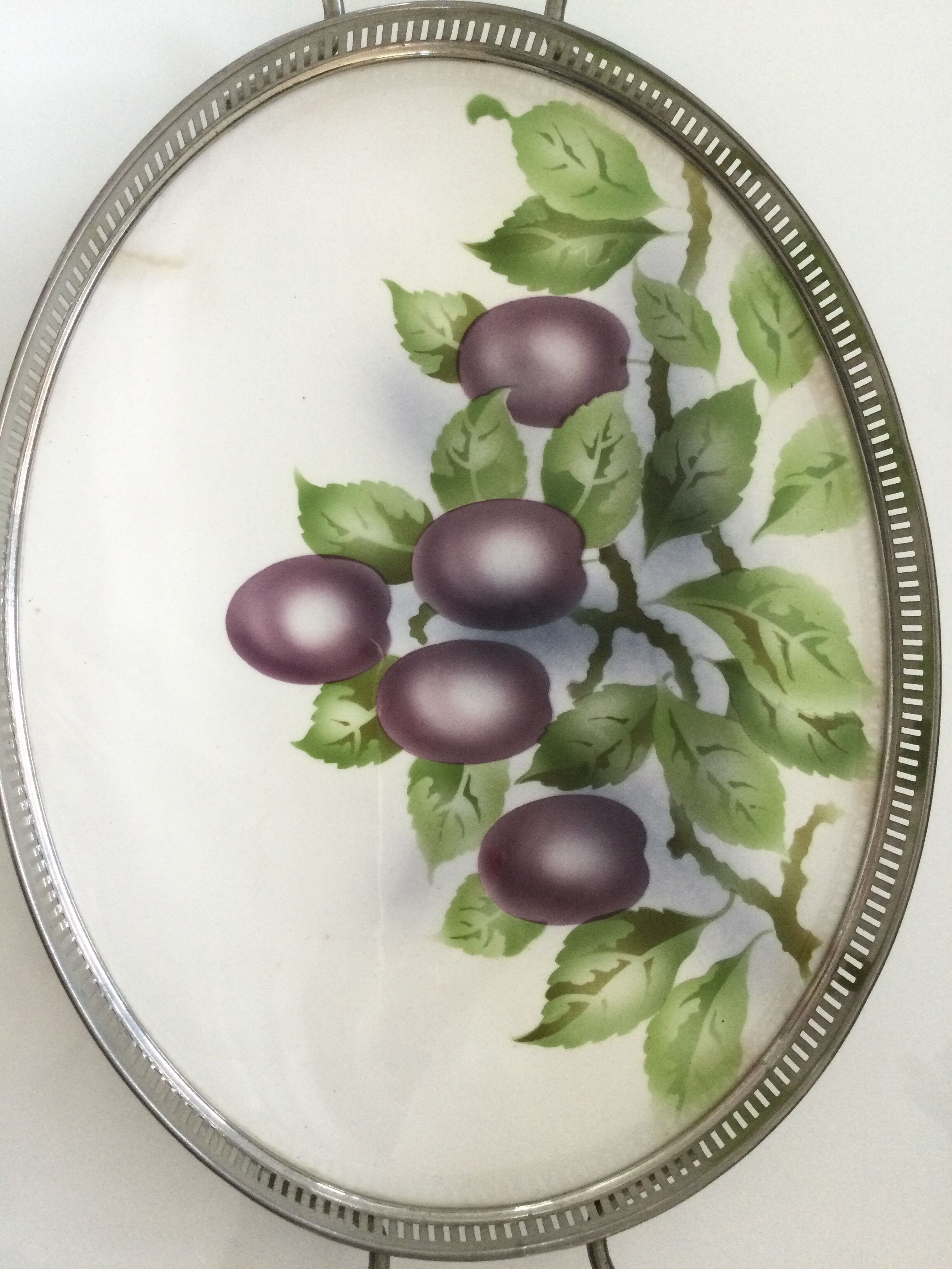 Vintage earthenware tray surrounded by antique metal