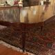 Extensible dining table from the Louis XVI period in mahogany with a banded top.