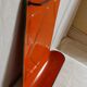 Orange enamelled kitchen utensil door