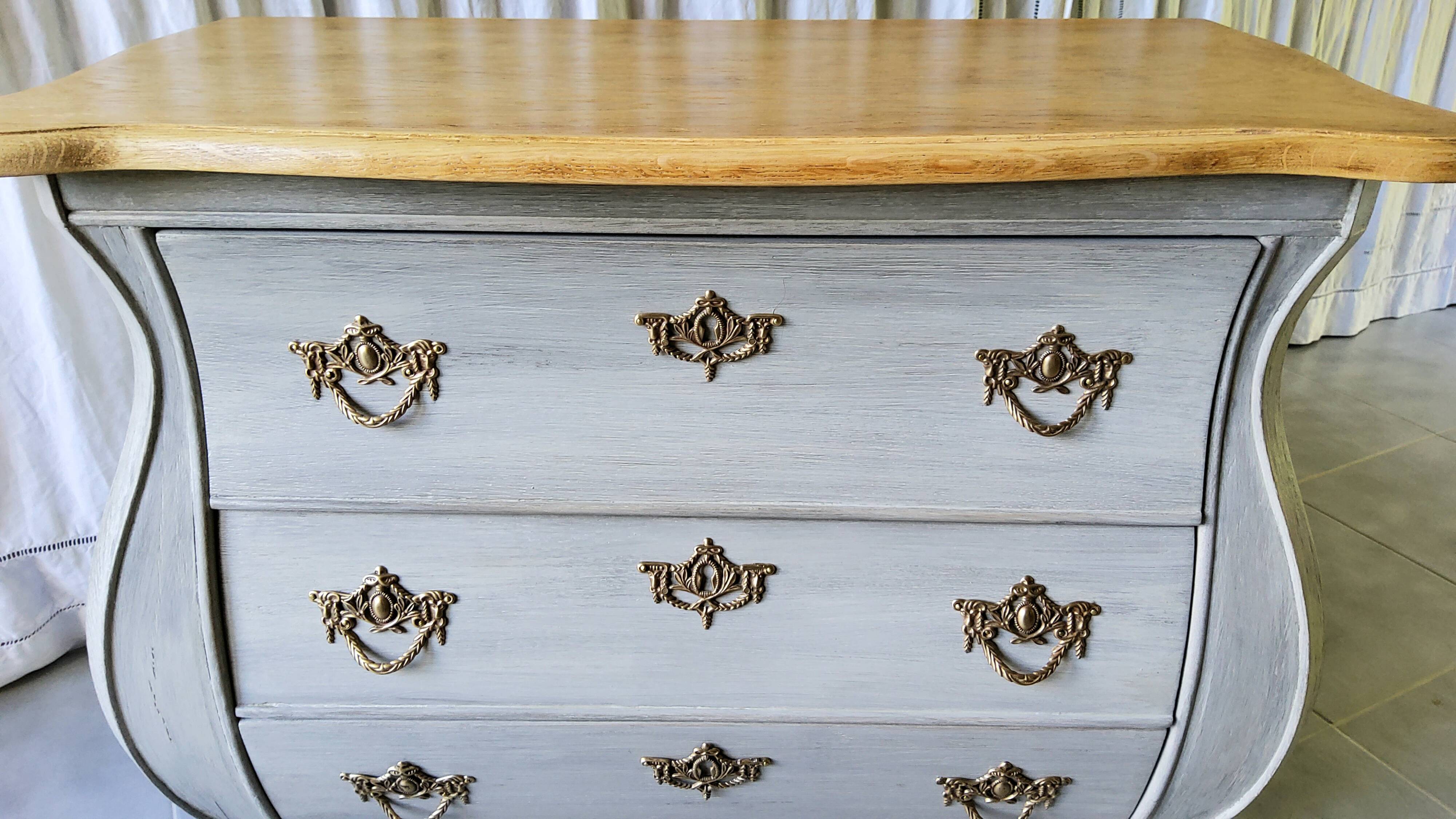Curved patinated chest of drawers