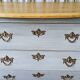 Curved patinated chest of drawers