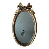 Old oval gilded stucco mirror