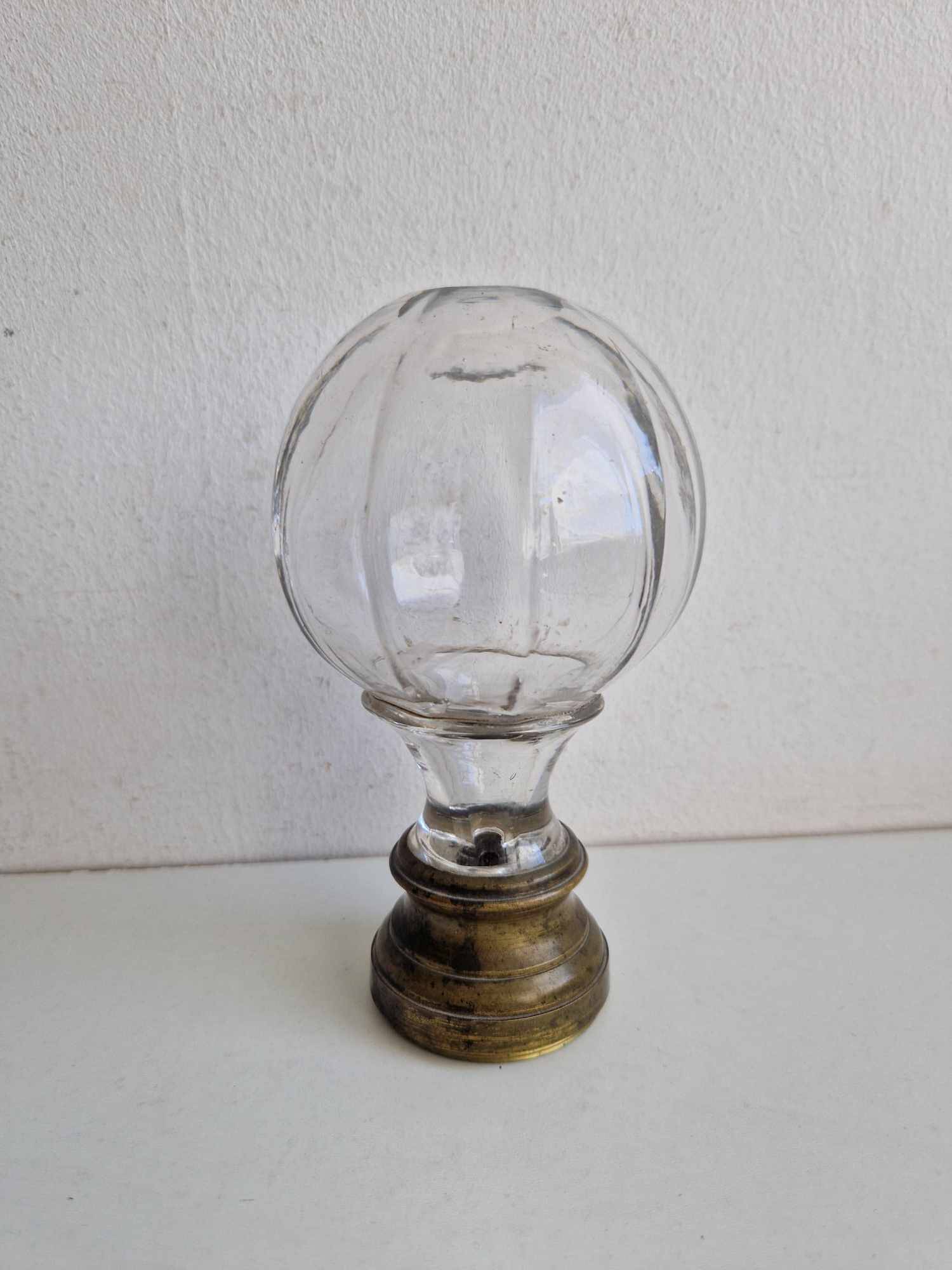 Glass and brass stair ball