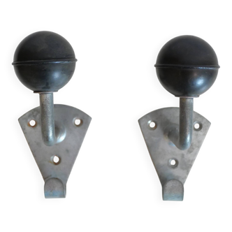 Pair of school coat hooks in Bakelite and metal from the 1950s.