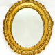 Antique oval mirror in gilded wood