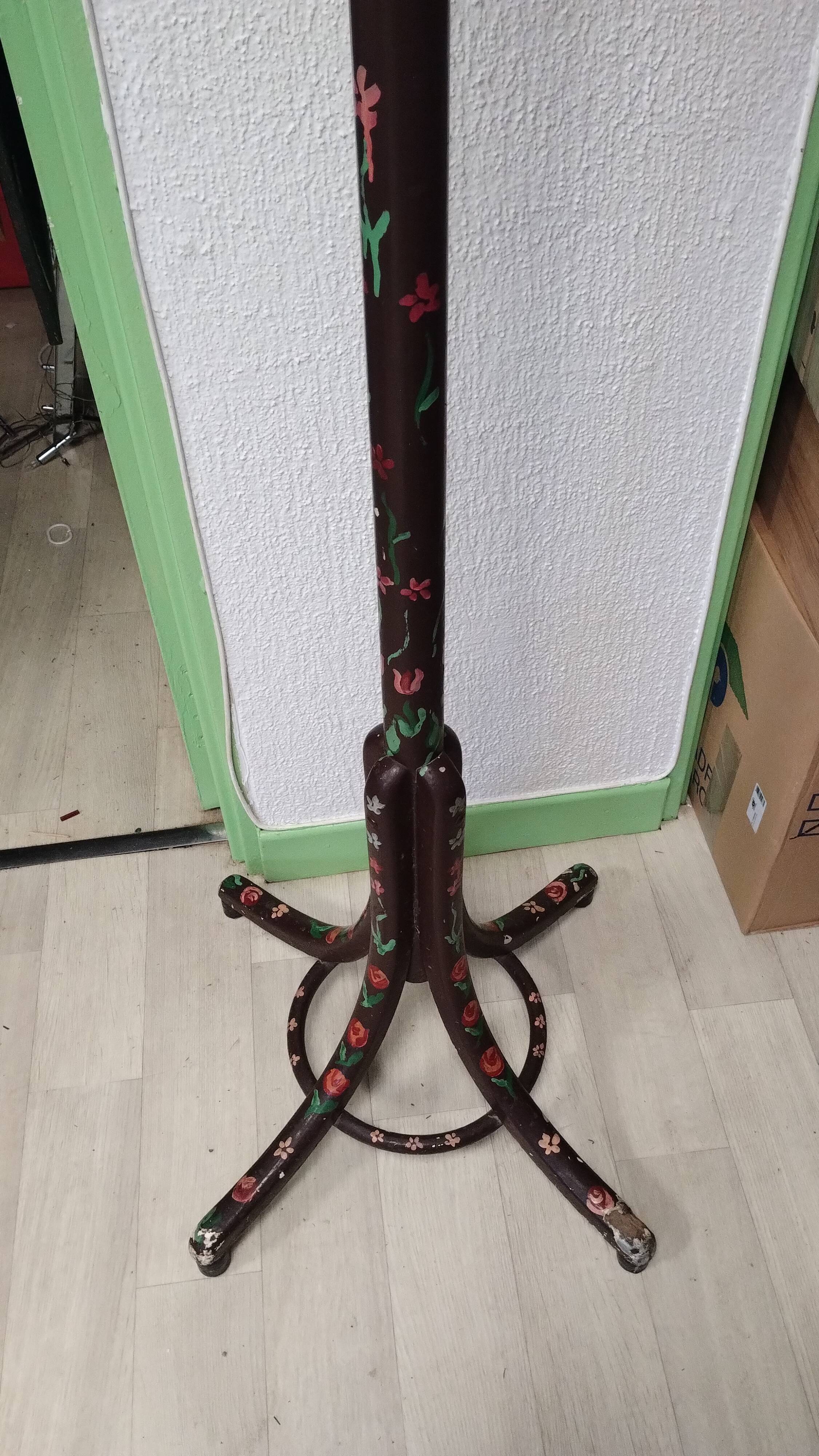 Wooden parrot coat rack with painted floral decoration.