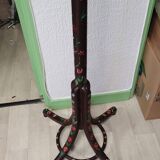Wooden parrot coat rack with painted floral decoration.