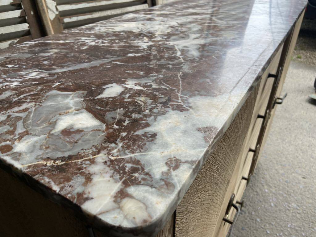 Raw wood chest of drawers with marble top