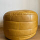 2 poufs moutarde patchwork en cuir de Sède