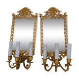Pair of wall lights with mirror backgrounds with 3 arms of lights in chiseled and gilded bronze. framing decorated with foliage and masks. louis xiv style